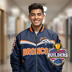 High school student wearing custom navy blue sublimation bomber jacket with Broncos mascot logo and text, showcasing School Spirit Builders nationwide apparel services